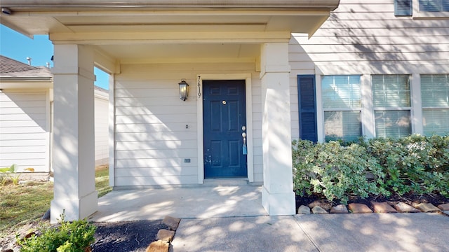 view of exterior entry with covered porch