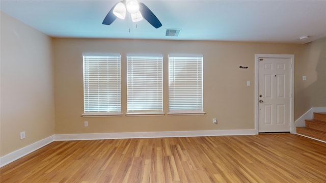 spare room featuring ceiling fan, plenty of natural light, and light hardwood / wood-style floors