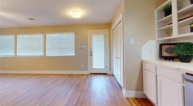 doorway to outside with a healthy amount of sunlight and light wood-type flooring