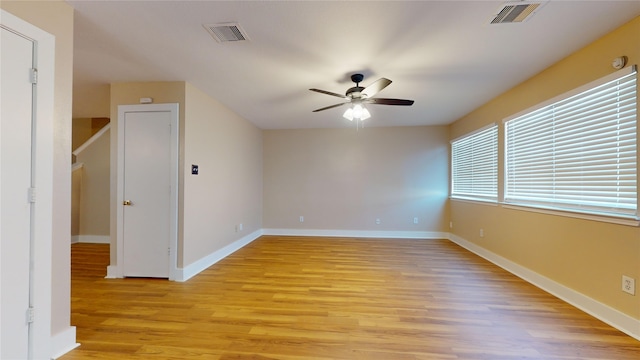 spare room with light wood-type flooring and ceiling fan