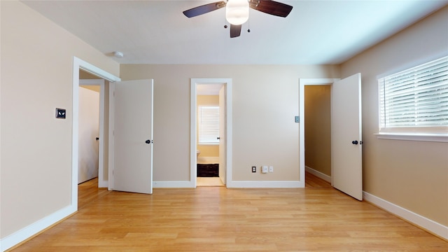 unfurnished bedroom with connected bathroom, light hardwood / wood-style floors, and ceiling fan