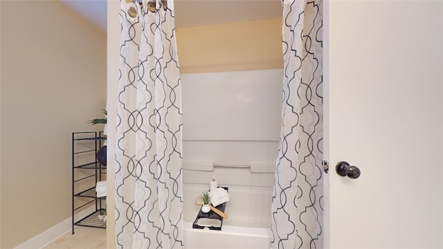 bathroom featuring tile patterned flooring and shower / bath combo