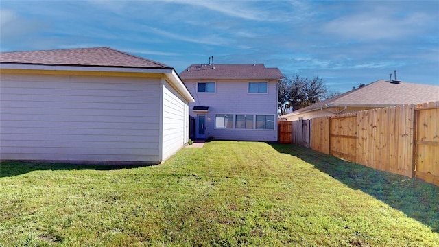 back of house featuring a lawn