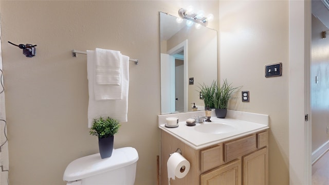 bathroom featuring vanity and toilet