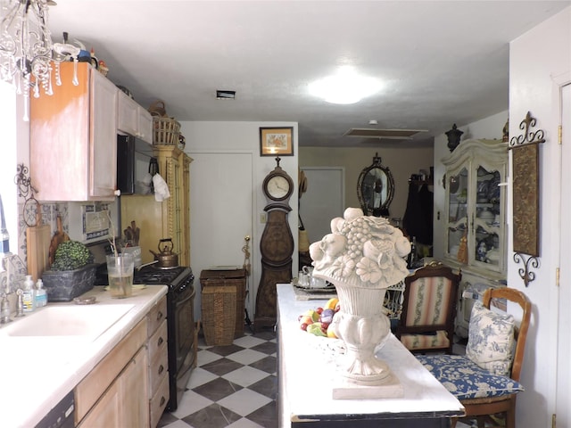 kitchen featuring black appliances, sink, and light brown cabinetry