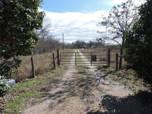 view of gate with a rural view