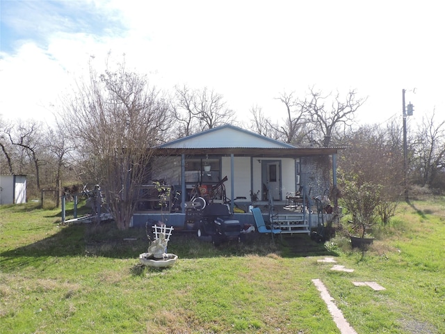 exterior space featuring a lawn and covered porch