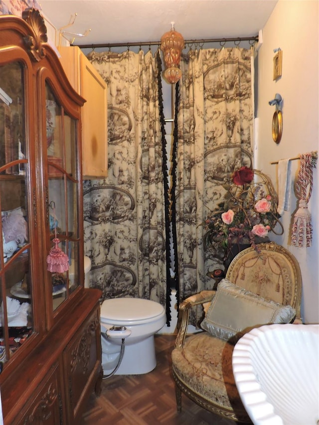 bathroom featuring toilet and parquet floors