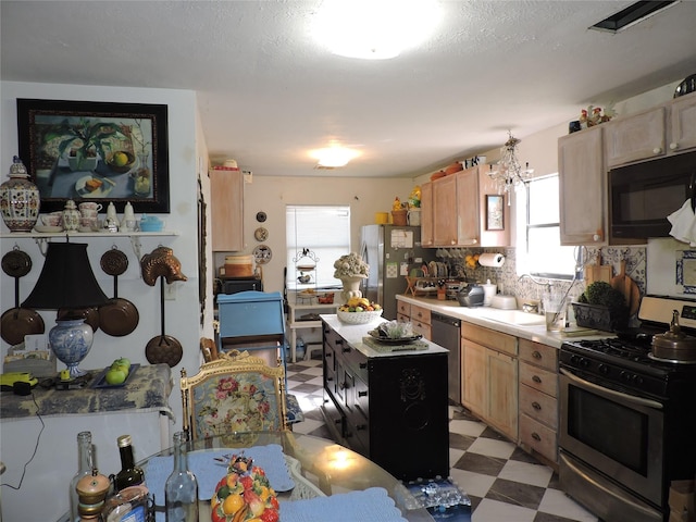 kitchen with light brown cabinetry, stainless steel appliances, tasteful backsplash, and sink