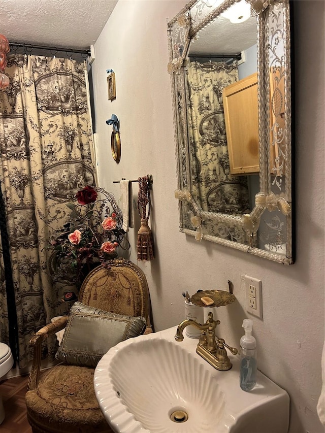 bathroom with sink and a textured ceiling