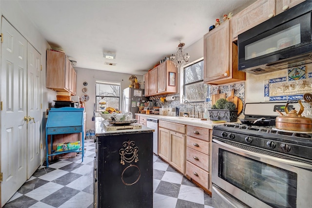 kitchen featuring tasteful backsplash, appliances with stainless steel finishes, sink, and light brown cabinets