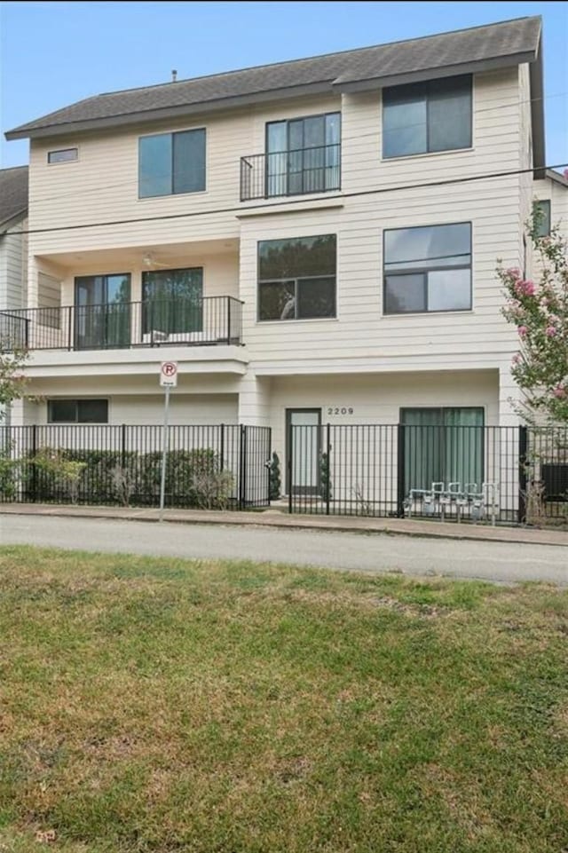 rear view of house featuring a lawn