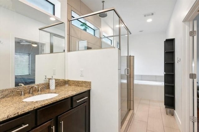 bathroom with vanity, plus walk in shower, and tile patterned floors