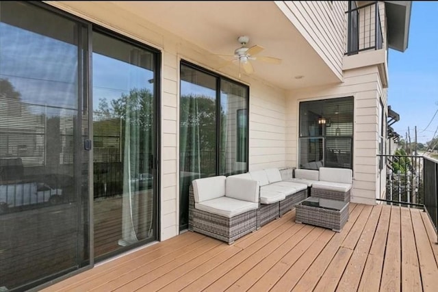 wooden deck with ceiling fan and an outdoor hangout area