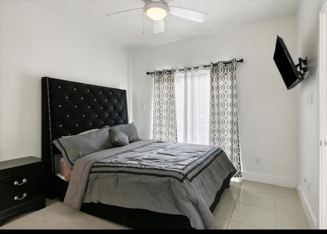 tiled bedroom with ceiling fan