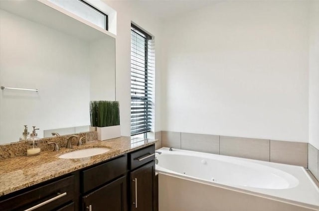 bathroom featuring a bath and vanity