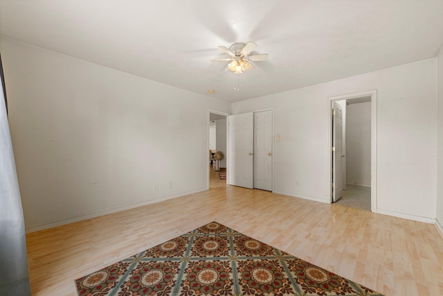 unfurnished bedroom featuring ceiling fan, a closet, and light hardwood / wood-style floors