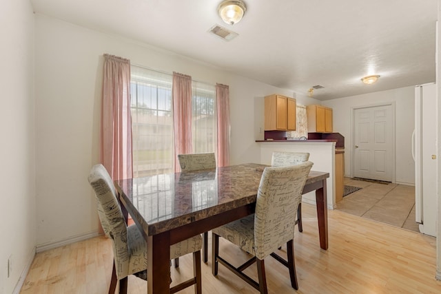 dining room with light hardwood / wood-style floors