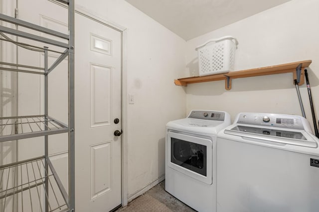 clothes washing area with washing machine and dryer