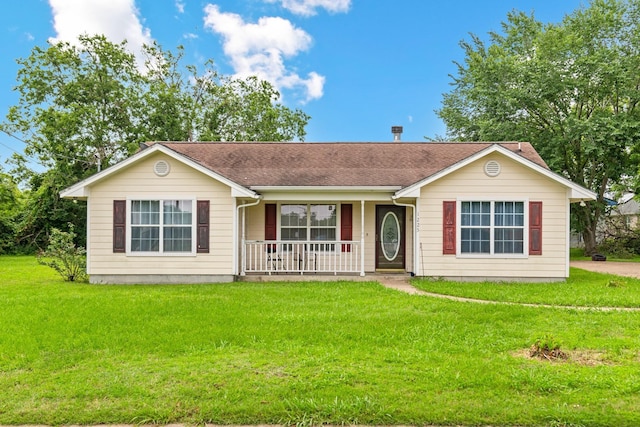 ranch-style house featuring a front yard and covered porch