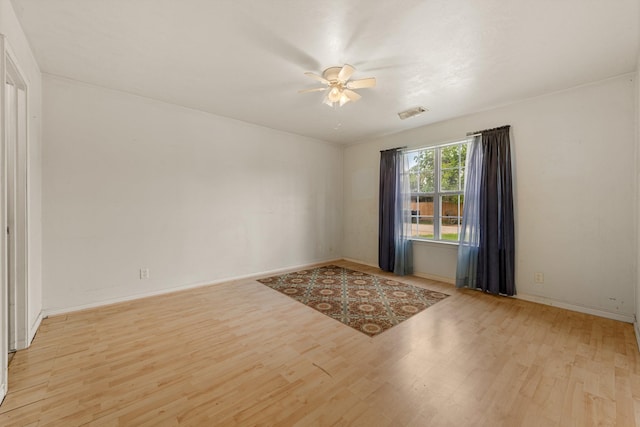 empty room featuring ceiling fan and light wood-type flooring