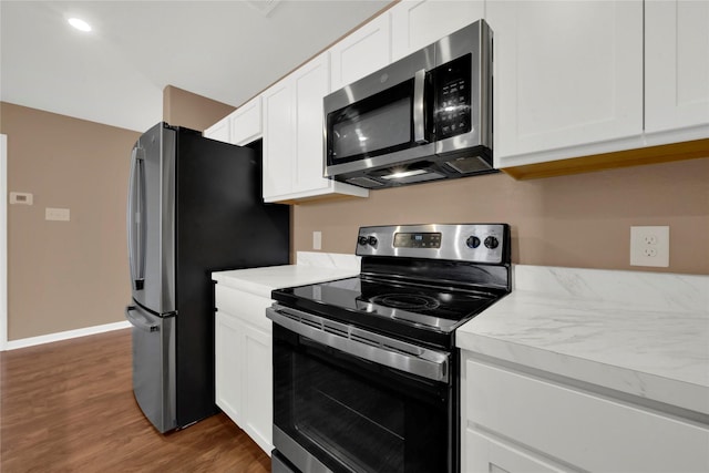 kitchen featuring dark hardwood / wood-style flooring, white cabinets, and appliances with stainless steel finishes