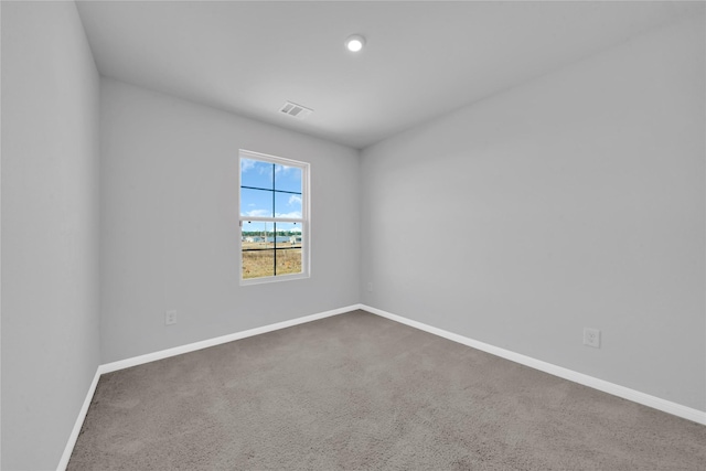 unfurnished room featuring dark colored carpet