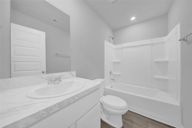 full bathroom featuring hardwood / wood-style flooring, vanity, toilet, and bathing tub / shower combination