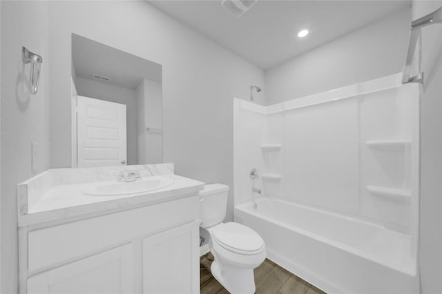 full bathroom featuring hardwood / wood-style flooring, vanity, toilet, and bathtub / shower combination