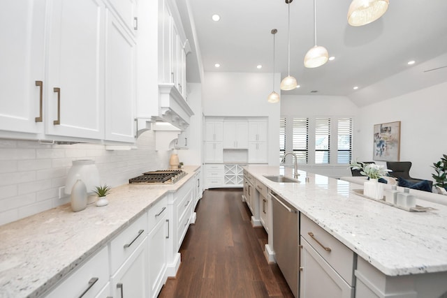 kitchen with appliances with stainless steel finishes, a spacious island, sink, pendant lighting, and white cabinets