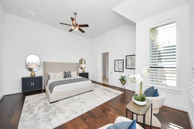 bedroom with multiple windows, dark hardwood / wood-style flooring, and ceiling fan