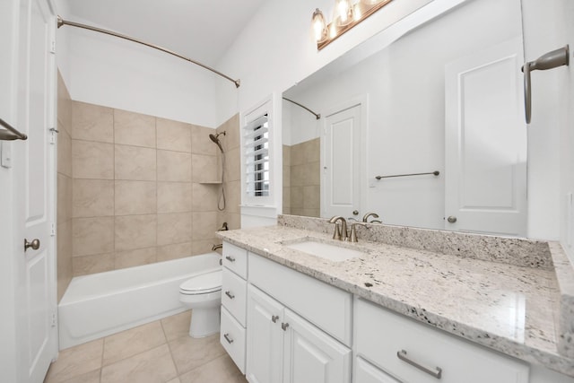 full bathroom with tile patterned floors, vanity, toilet, and tiled shower / bath