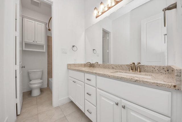 bathroom with tile patterned flooring, vanity, and toilet