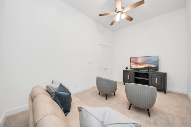 living room featuring ceiling fan, light colored carpet, and lofted ceiling