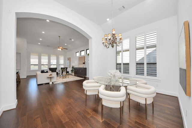 dining room featuring ceiling fan with notable chandelier, dark hardwood / wood-style floors, and lofted ceiling