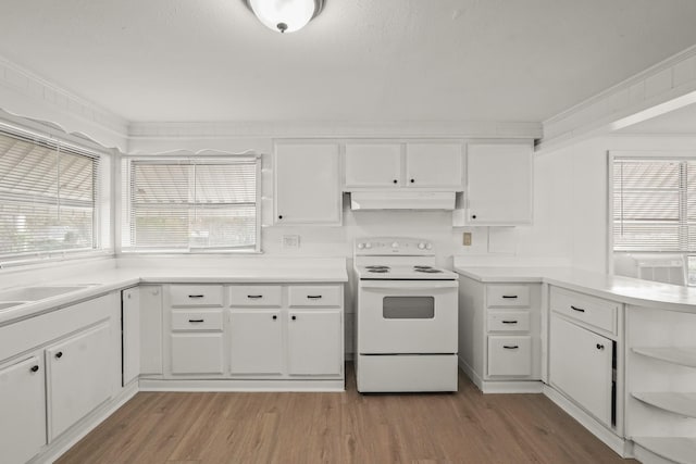 kitchen with white cabinets, light wood-type flooring, ornamental molding, and electric stove