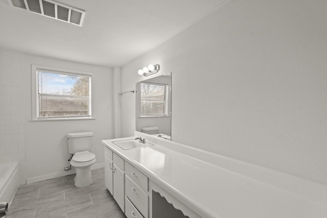 bathroom featuring vanity and toilet