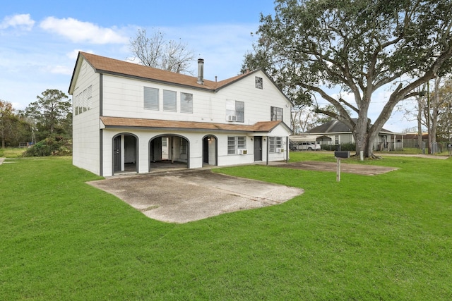 rear view of property featuring a lawn and a patio