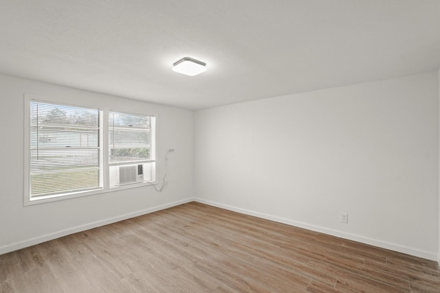 unfurnished room with light hardwood / wood-style flooring and cooling unit