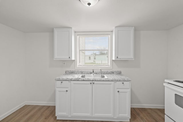 kitchen featuring white cabinetry, sink, hardwood / wood-style flooring, and white electric range