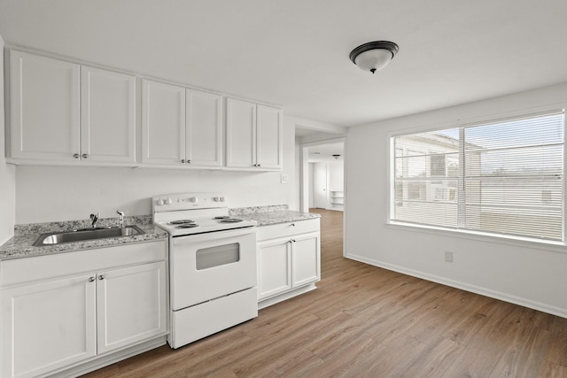 kitchen featuring white cabinets, white range with electric stovetop, light stone countertops, and sink