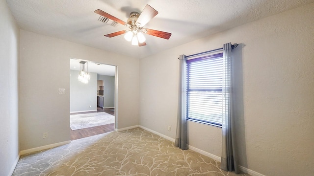 empty room featuring a textured ceiling and ceiling fan