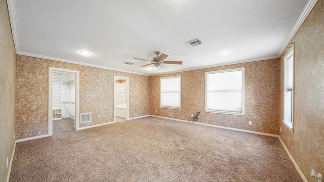 unfurnished room with carpet, ceiling fan, and ornamental molding