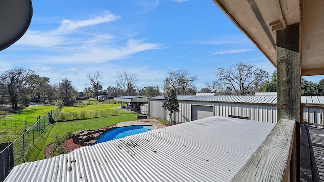 exterior space featuring a yard, a fenced in pool, and an outdoor structure