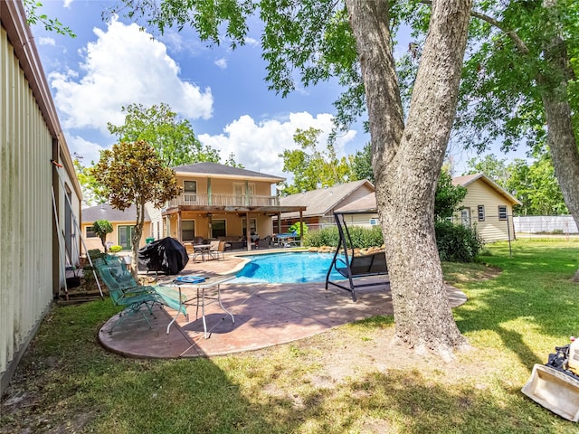 view of swimming pool with a yard, a patio, and grilling area