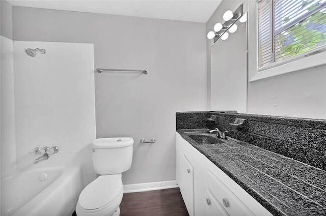 full bathroom with shower / bathing tub combination, vanity, hardwood / wood-style flooring, and toilet