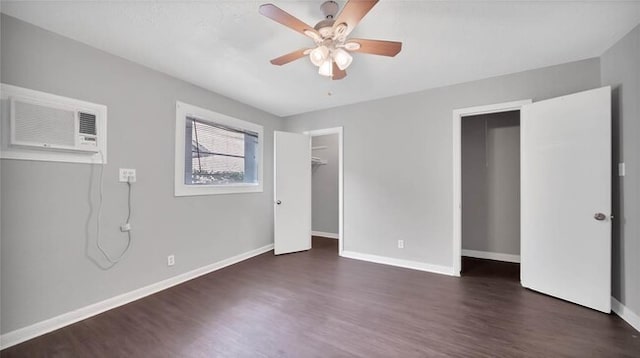 unfurnished bedroom featuring a wall mounted AC, ceiling fan, and dark hardwood / wood-style floors