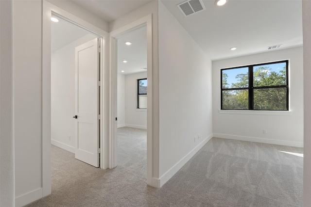 corridor featuring light carpet