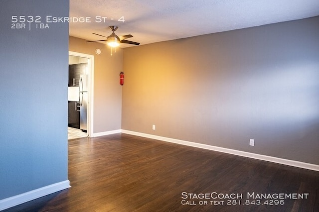 empty room featuring ceiling fan and dark hardwood / wood-style flooring