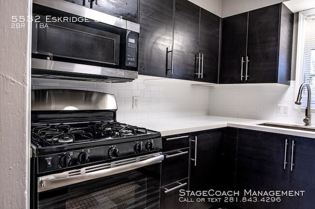 kitchen with backsplash, sink, and stainless steel appliances